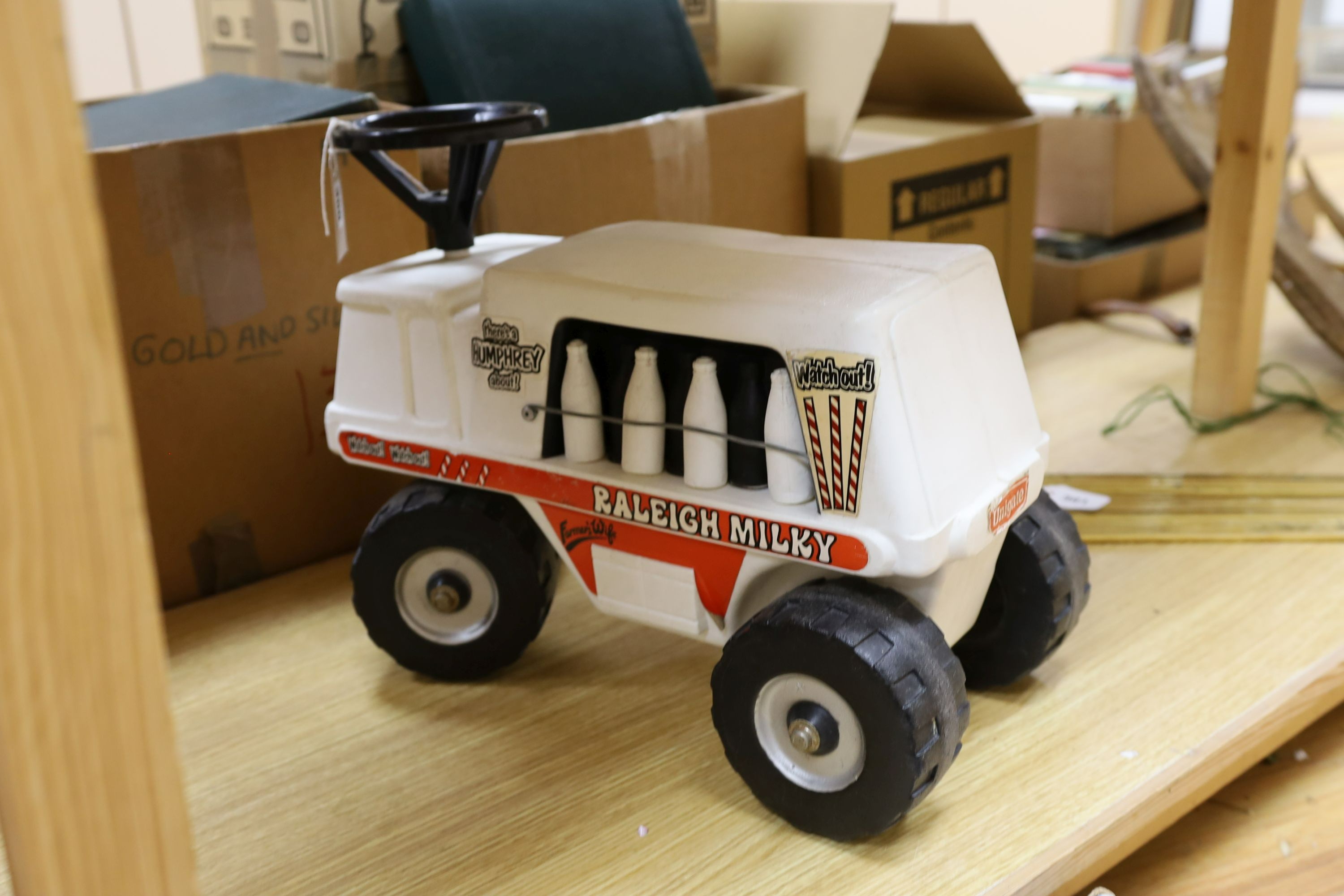 A Denys Fisher Superman, rare in original box, another unboxed, a Unigate milk float with bottles, and a boxed Evel Knievel Stunt Cycle